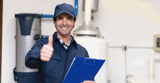 Plumber holding a clipboard with water heater behind him.