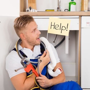 Plumber Holding Flag that Says Help!