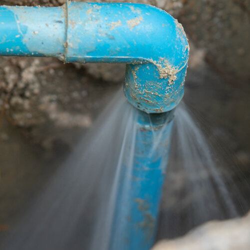 Blue pipe gushing water.