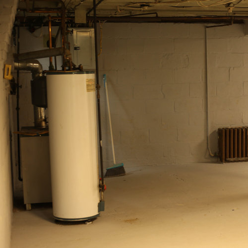 view of water heater in a basement
