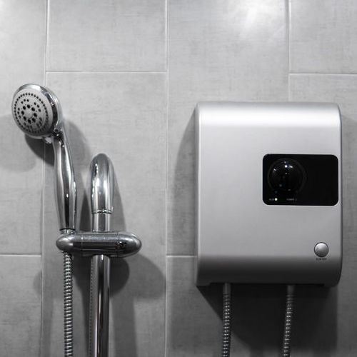 A Small Tankless Water Heater Next to a Shower.